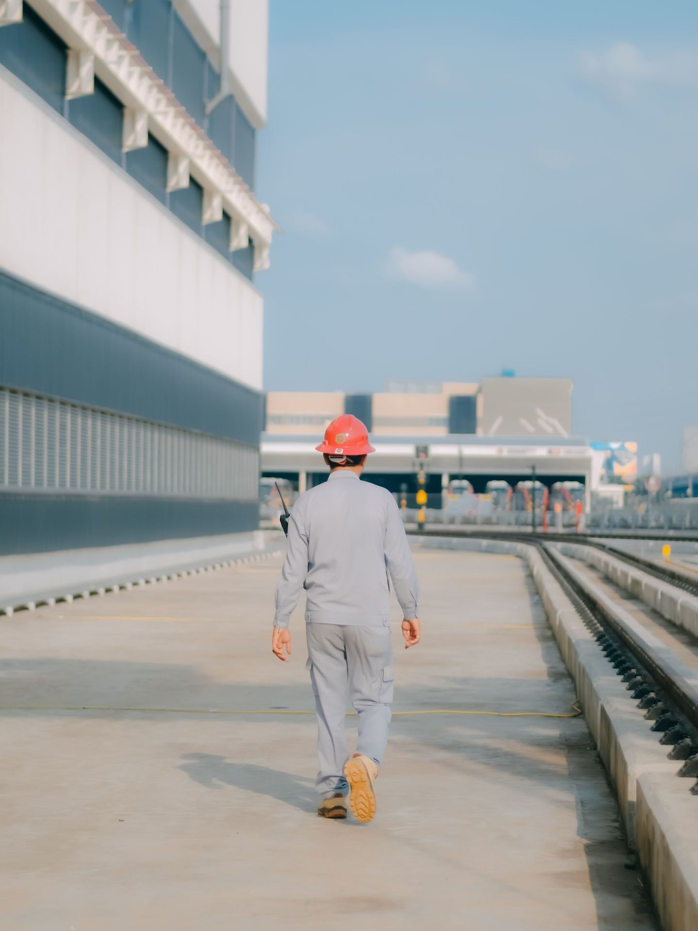 Engineer inspecting alloy pipe stock in warehouse